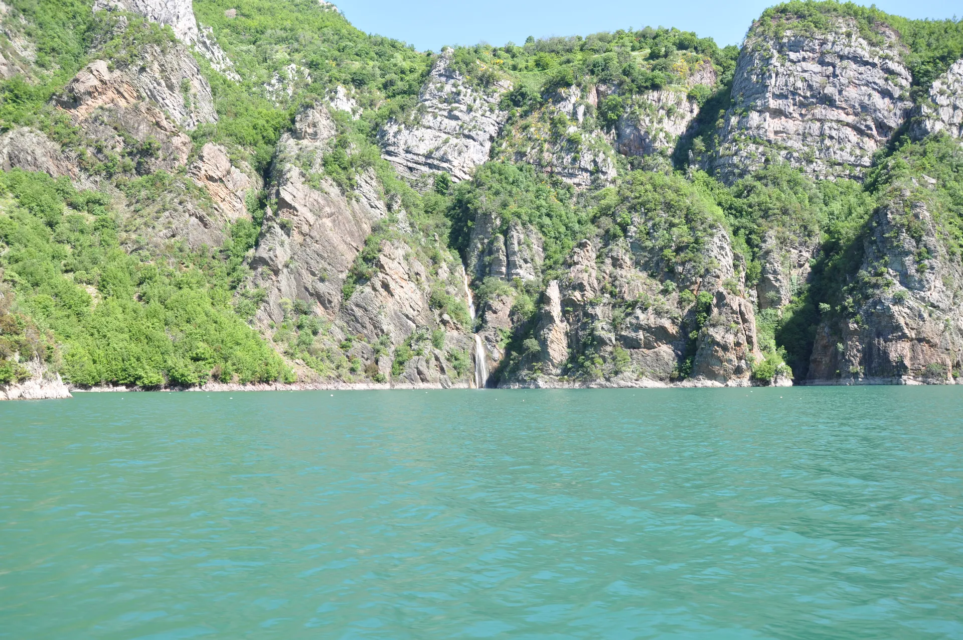 Vastness of the Koman Lake reservoir captured from a remote high-altitude viewpoint.