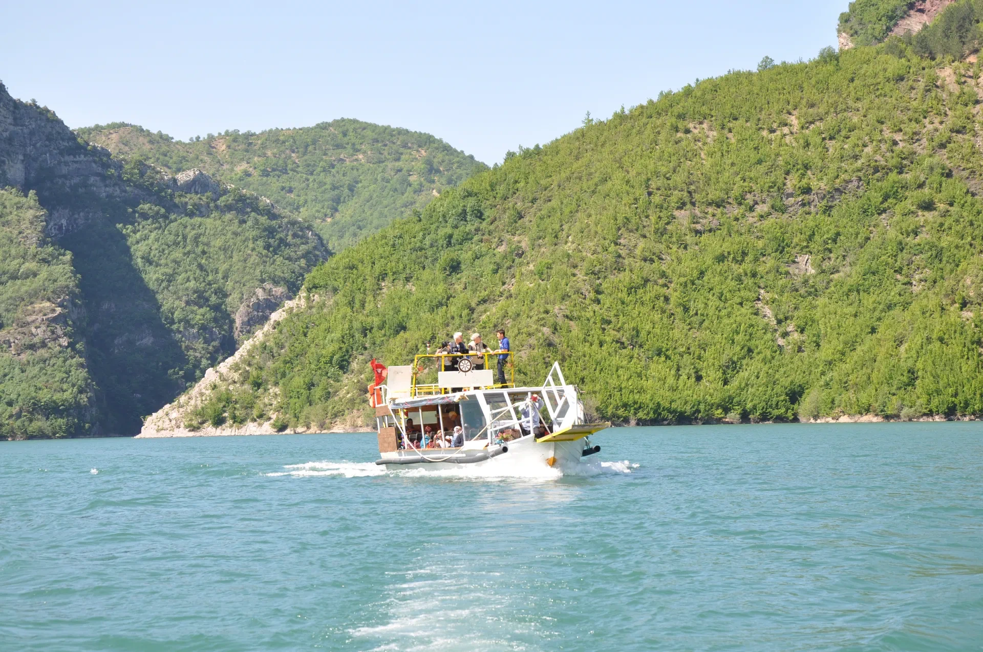 A tour boat carrying passengers through the spectacular gorges.