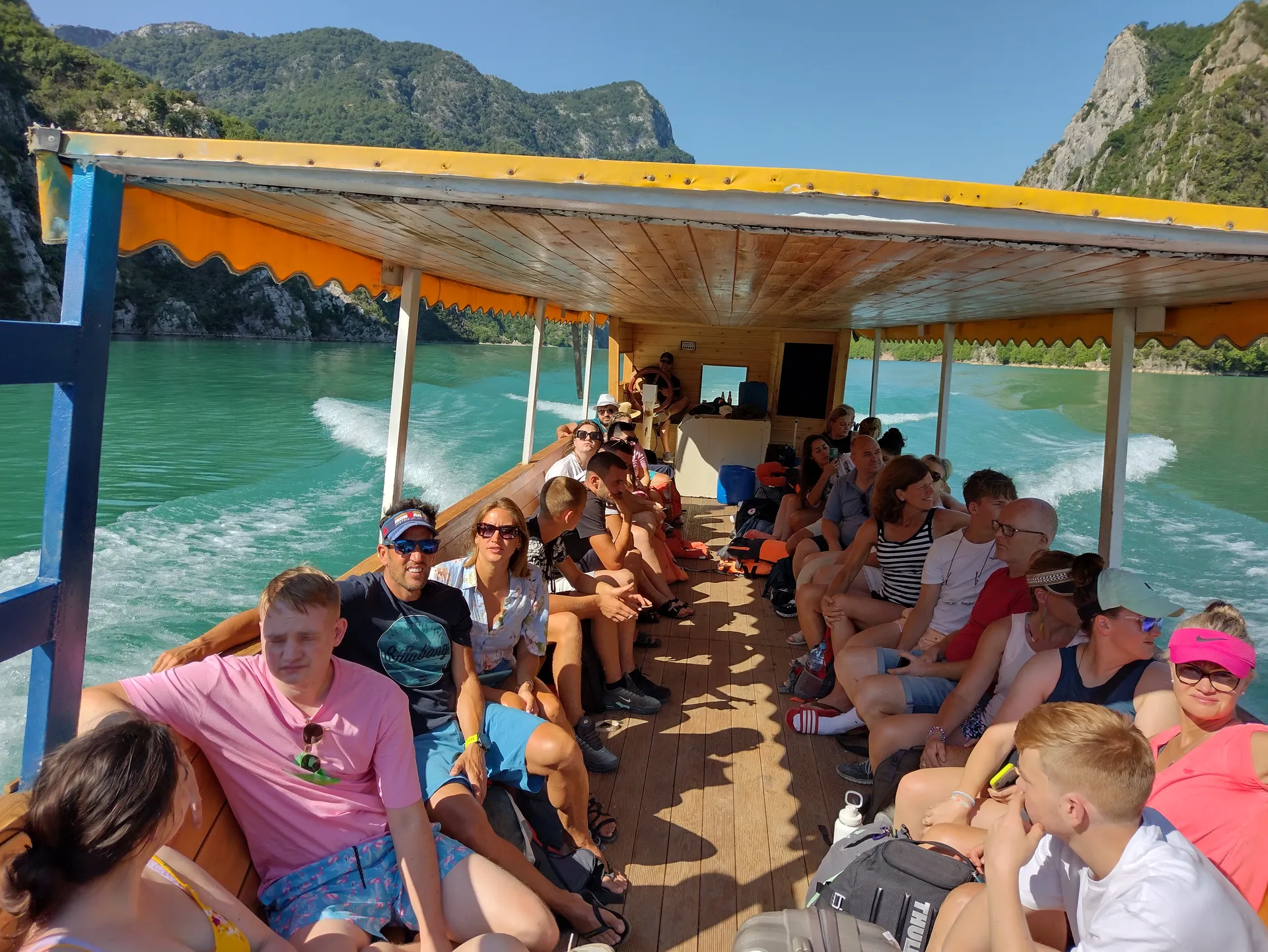 Happy tourists relaxing and enjoying the views from inside the tour boat.