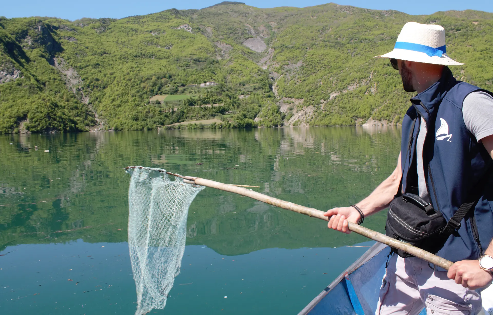 Local guide using a net to help keep the waters pristine.