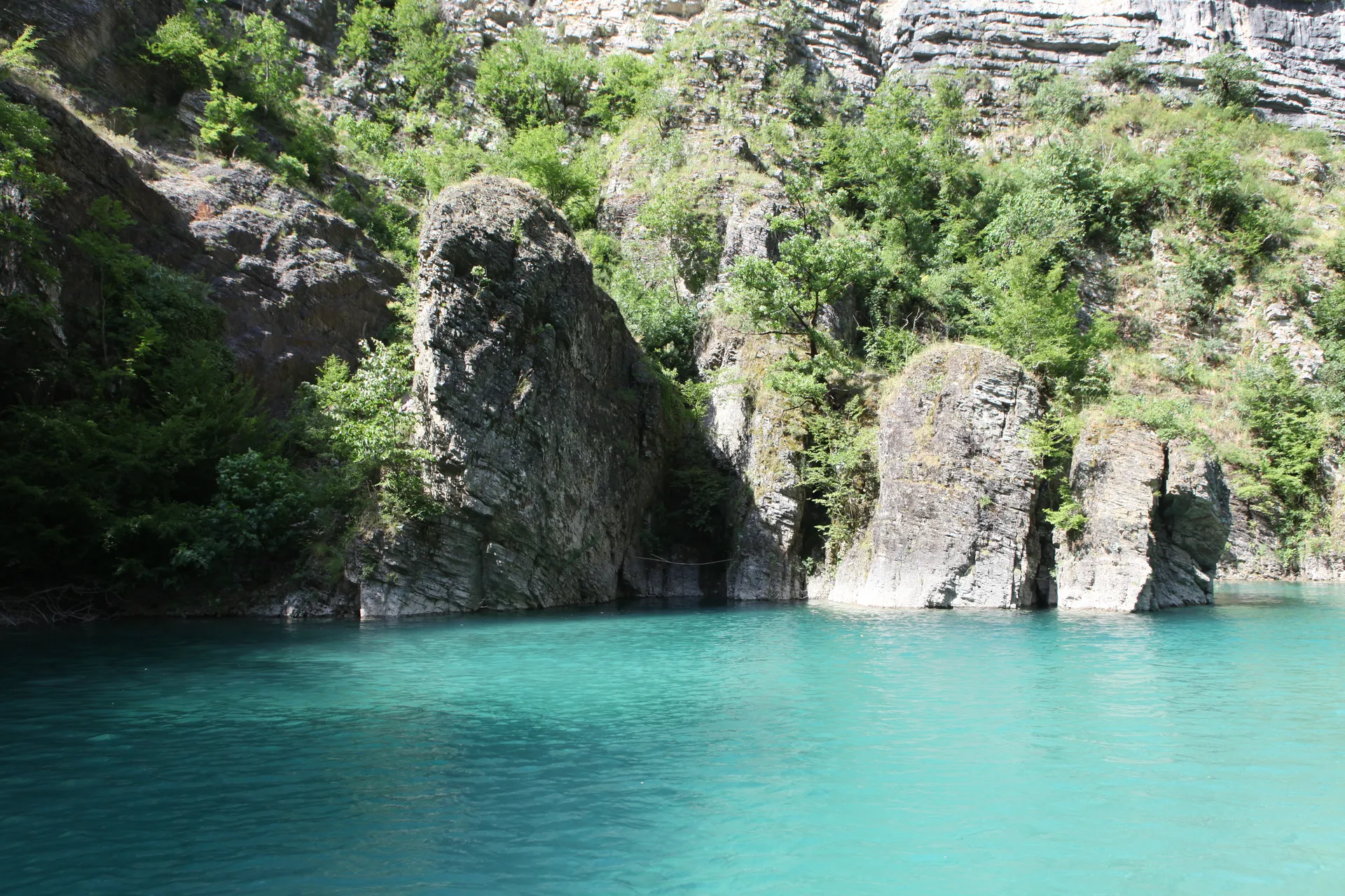 Unique geological rock formations along the shoreline sculpted by wind and water.