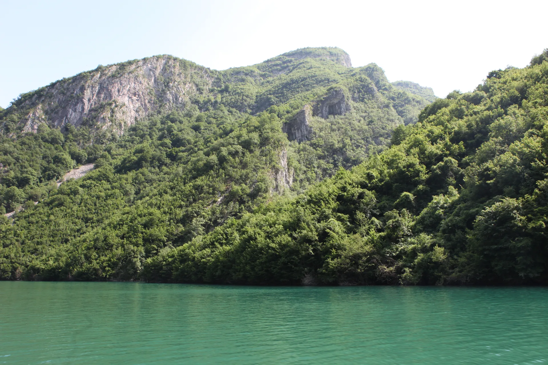Serpentine river winding through the deep valley towards the main reservoir.